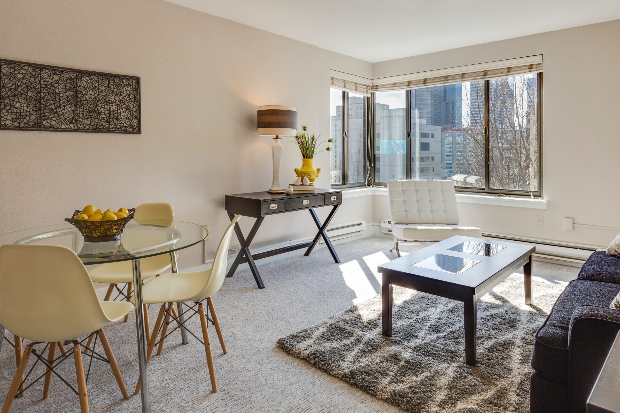 a living room with a glass tabletop